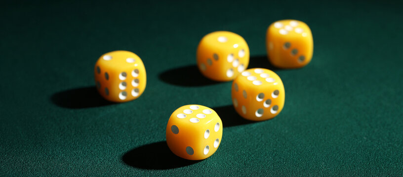 Yellow game dices on dark green background