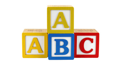 Colorful wooden toy blocks stacked featuring the letters "A", "B", and "C" against a stark black backdrop