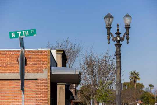 Afternoon view of historic wrought iron light posts in historic downtown Fowler, California, USA.
