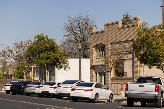 Afternoon sun shines on historic buildings in downtown Fowler, California, USA.