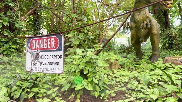 Velociraptor Animatronic Approaches Warning Sign in Lush Forest