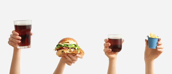 Female hands with tasty burger, french fries and glasses of cola on white background