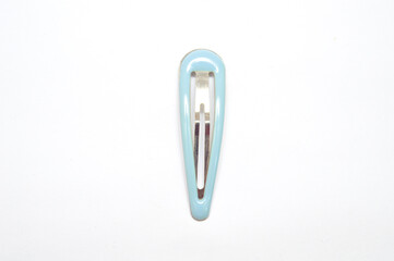 Close-up of a single light blue, glossy snap hair clip, barrette, isolated vertically on a pure white background. Represents beauty, fashion accessory, minimalist design, and childhood concept.