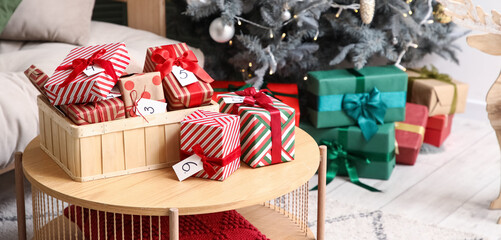 Box with Christmas Advent calendar on table in living room, closeup