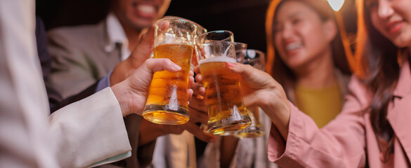Happy Group of people Asian friends Drinking beer outdoors at the brewery for the New Year festival night time
