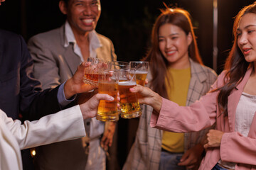 Happy Group of people Asian friends Drinking beer outdoors at the brewery for the New Year festival night time
people
