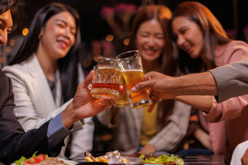 Happy Group of people Asian friends Drinking beer outdoors at the brewery for the New Year festival night time
people