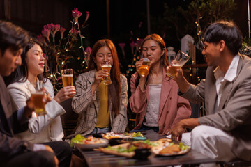 Happy Group of people Asian friends Drinking beer outdoors at the brewery for the New Year festival night time
people