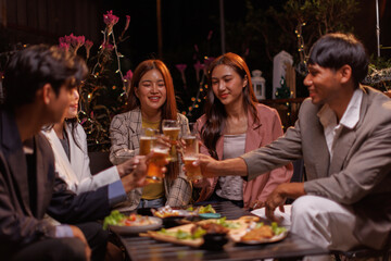 Happy Group of people Asian friends Drinking beer outdoors at the brewery for the New Year festival night time
people