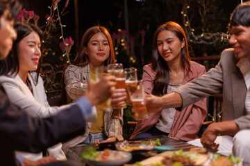 Happy Group of people Asian friends Drinking beer outdoors at the brewery for the New Year festival night time
people