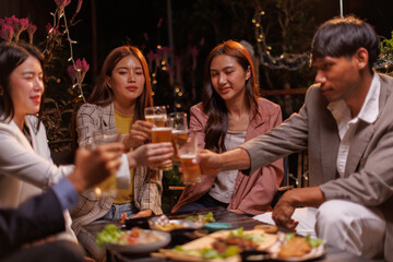 Happy Group of people Asian friends Drinking beer outdoors at the brewery for the New Year festival night time
people