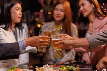 Happy Group of people Asian friends Drinking beer outdoors at the brewery for the New Year festival night time
people