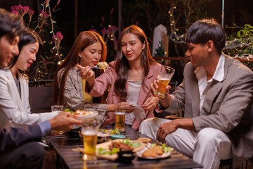 Happy Group of people Asian friends Drinking beer outdoors at the brewery for the New Year festival night time
people