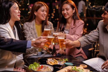 Happy Group of people Asian friends Drinking beer outdoors at the brewery for the New Year festival night time
people