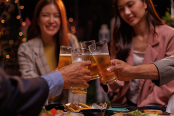 Happy Group of people Asian friends Drinking beer outdoors at the brewery for the New Year festival night time
people
