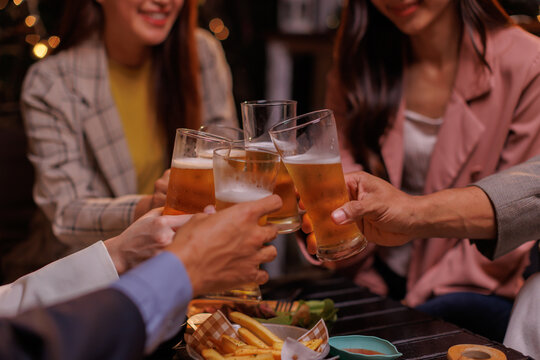 Happy Group of people Asian friends Drinking beer outdoors at the brewery for the New Year festival night time
people