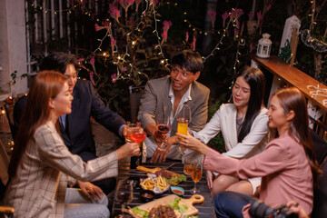 Group of people Throw a party Celebrate whiskey at a friendly party in a restaurant. Night.
