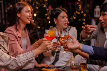 Group of people Throw a party Celebrate whiskey at a friendly party in a restaurant. Night.
