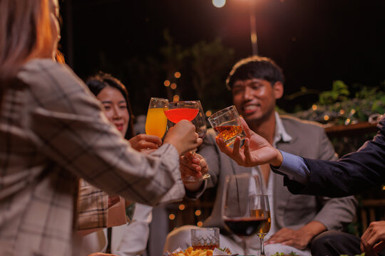 Group of people Throw a party Celebrate whiskey at a friendly party in a restaurant. Night.
