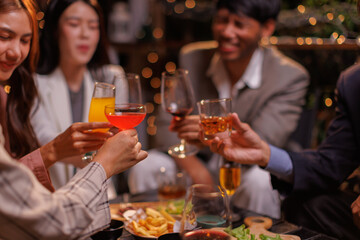 Group of people Throw a party Celebrate whiskey at a friendly party in a restaurant. Night.
