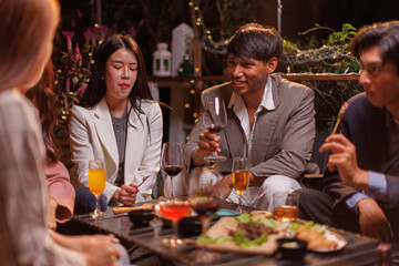 Group of people Throw a party Celebrate whiskey at a friendly party in a restaurant. Night.
