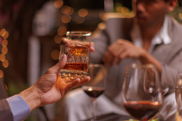 Happy Group of people clinking glasses of whiskey in celebration, Holiday, Festival celebration.
