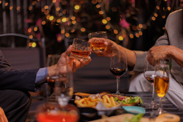 Happy Group of people clinking glasses of whiskey in celebration, Holiday, Festival celebration.
