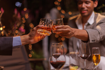 Happy Group of people clinking glasses of whiskey in celebration, Holiday, Festival celebration.
