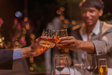 Happy Group of people clinking glasses of whiskey in celebration, Holiday, Festival celebration.
