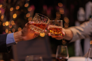 Happy Group of people clinking glasses of whiskey in celebration, Holiday, Festival celebration.
