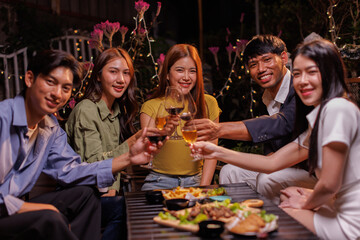 Glasses of Happy friends rose wine seen during a friendly party of a celebration.
