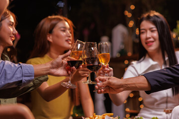 Glasses of Happy friends rose wine seen during a friendly party of a celebration.
