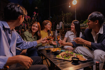 Glasses of Happy friends rose wine seen during a friendly party of a celebration.