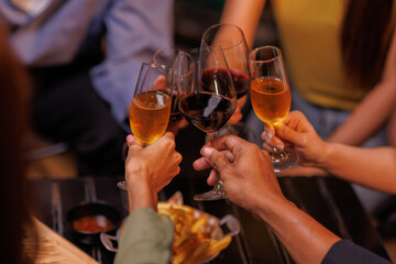 Group of people toasting with champagne glasses at a celebration. Hands holding champagne, clinking glasses. Festive atmosphere, joyful celebration, champagne toast. People toasting with champagne.

