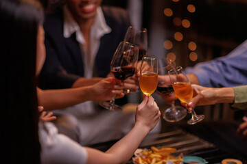 Group of people toasting with champagne glasses at a celebration. Hands holding champagne, clinking glasses. Festive atmosphere, joyful celebration, champagne toast. People toasting with champagne.
