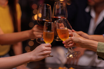 Group of people toasting with champagne glasses at a celebration. Hands holding champagne, clinking glasses. Festive atmosphere, joyful celebration, champagne toast. People toasting with champagne.
