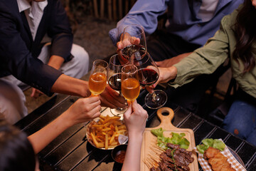 Group of people toasting with champagne glasses at a celebration. Hands holding champagne, clinking glasses. Festive atmosphere, joyful celebration, champagne toast. People toasting with champagne.
