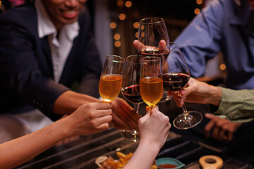 Group of people toasting with champagne glasses at a celebration. Hands holding champagne, clinking glasses. Festive atmosphere, joyful celebration, champagne toast. People toasting with champagne.
