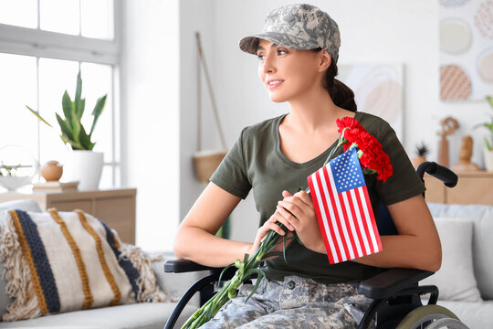 Female soldier with USA flag and carnation flowers in wheelchair at home - Powered by Adobe