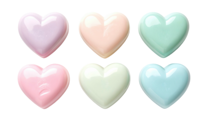 Six pastel-colored candy hearts, arranged in two rows against a black background, with soft lighting