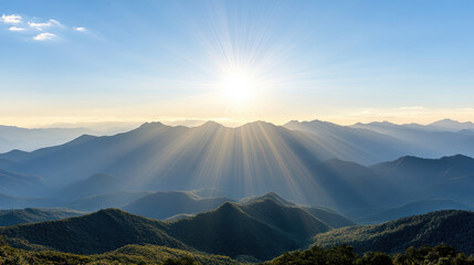 Obraz premium Sunlight scattering over layers of distant mountain ranges creates breathtaking view