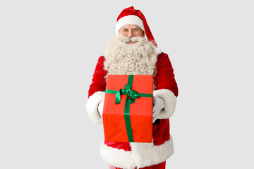 Santa Claus with Christmas gift on white background