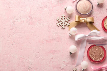 Beautiful composition with Christmas balls, highlighter, wooden snowflakes and bows on pink grunge background