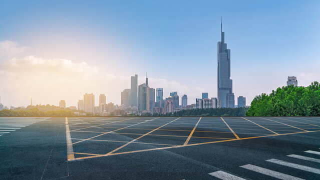 Urban city skyline with empty parking lot under clear sky - Powered by Adobe