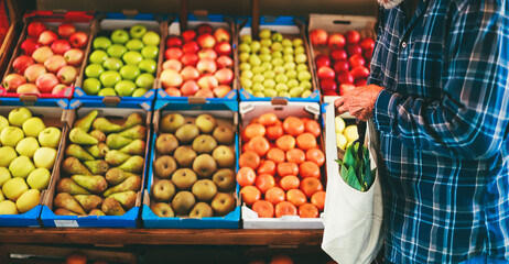 Senior man buying fresh fruits at market, closeup. Healthy food and lifestyle concept
