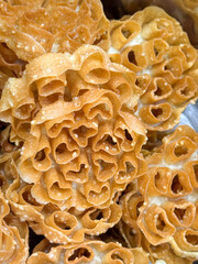 A bunch of golden pastries with a heart shape