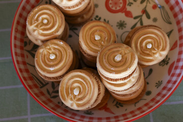 Delightful homemade toasted spiral cookies in bowl. Sweet dessert food and fresh baking create delicious biscuit treat for cozy and comforting snack experience