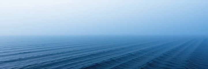 Fototapeta premium Misty fog hovers over a tranquil, deep blue ocean expanse, outdoors, blue