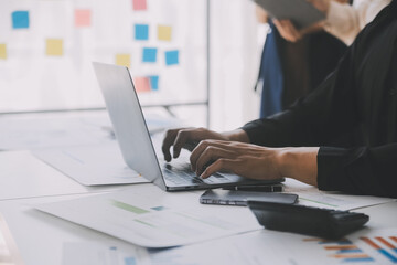 Financial analysts analyze business financial reports on a digital tablet planning investment project during a discussion at a meeting of corporate showing the results of their successful teamwork.