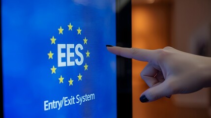 Modern EU Entry Exit System touchscreen kiosk being operated by a traveler, showing digital border control technology and biometric registration interface